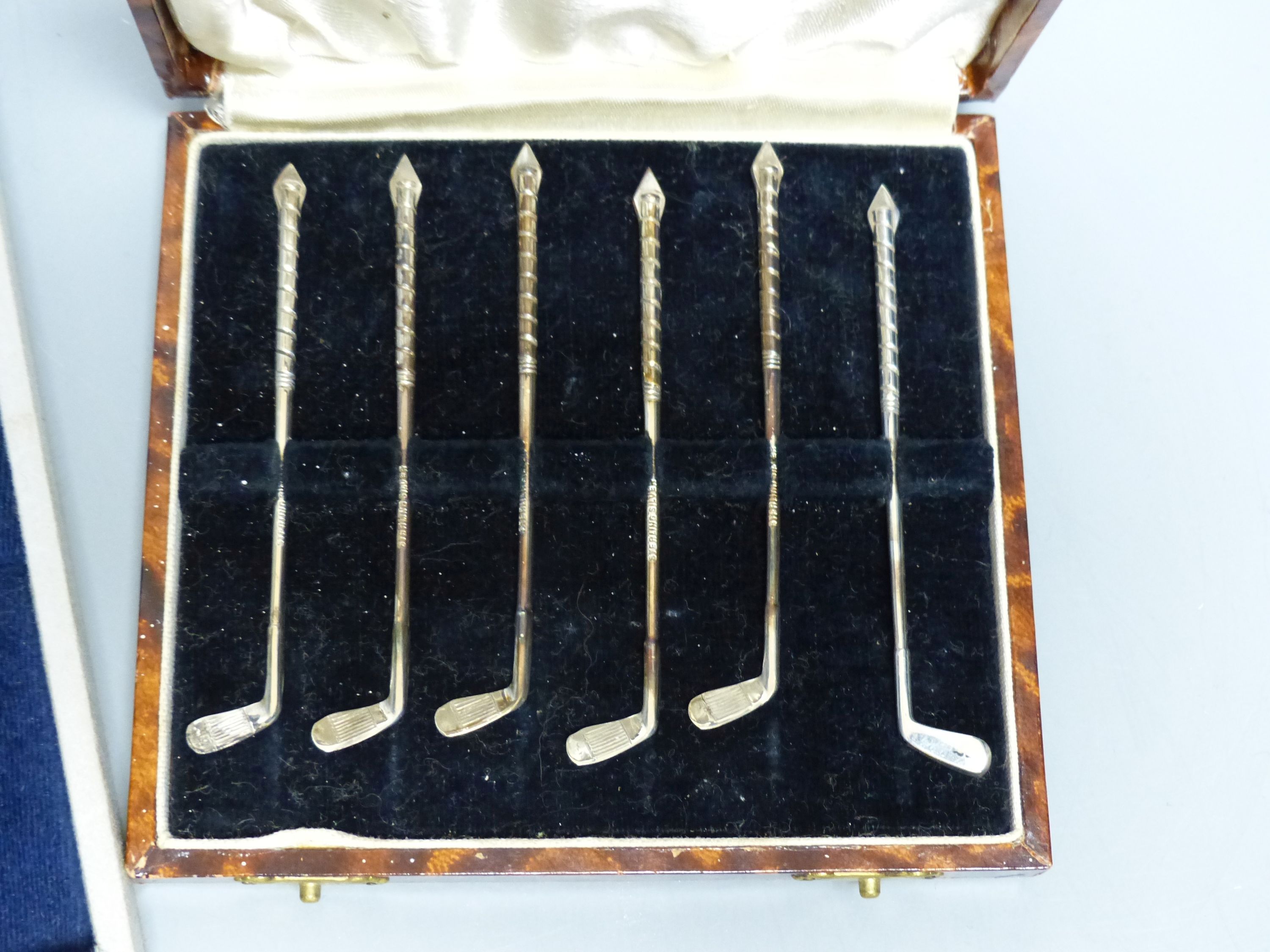 Two cased sets- Dutch white metal spoons & forks and a set of six sterling 'golf club' cocktail sticks? & 4 other spoons.